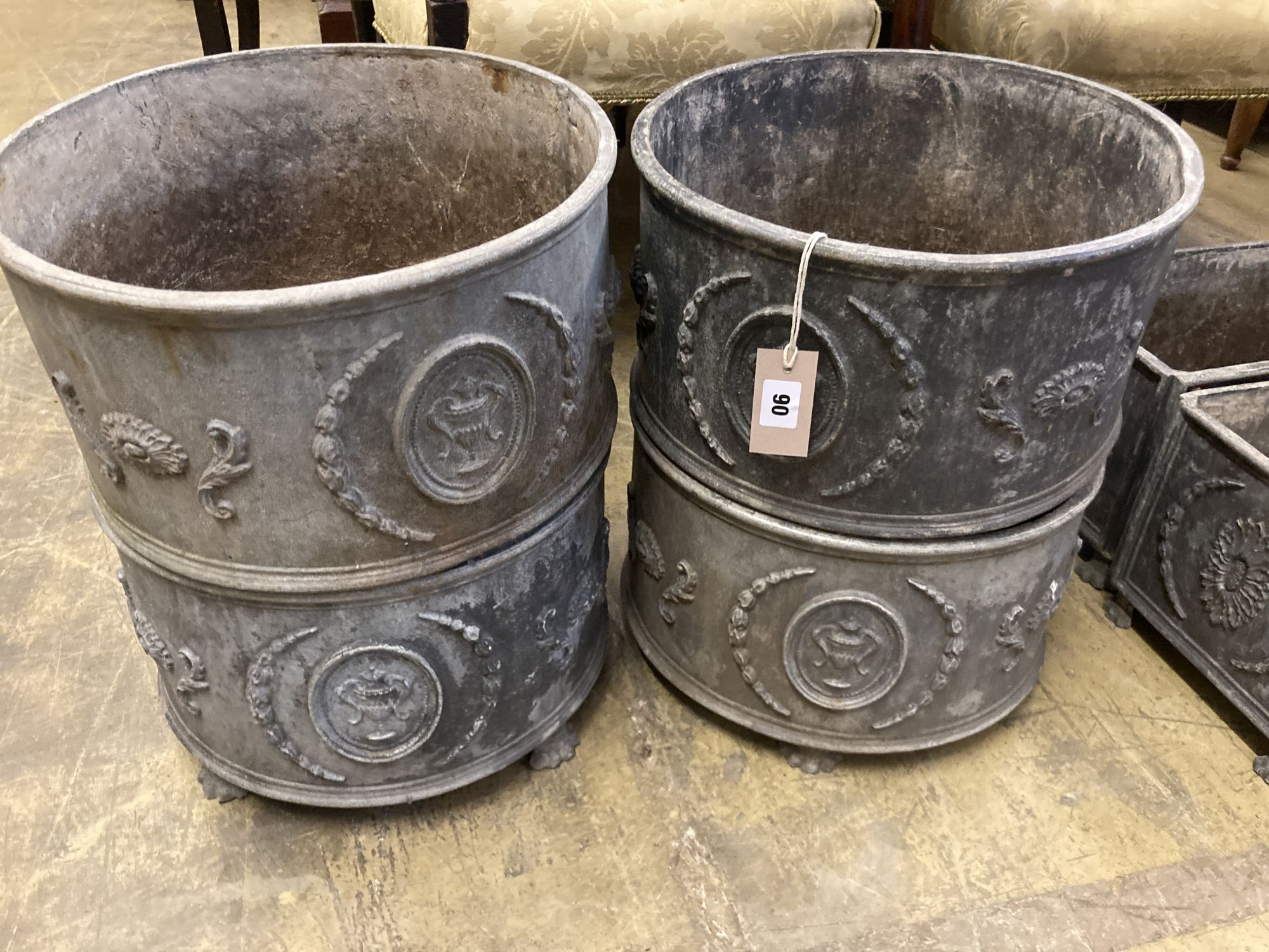 A set of four circular lead garden planters, 37cm diameter, height 20cm